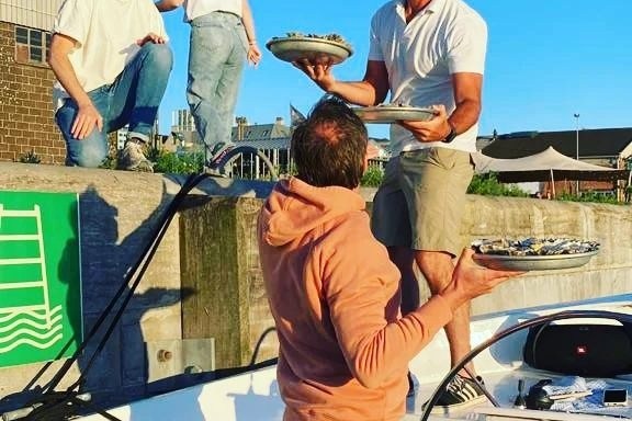 a group of people standing next to a man