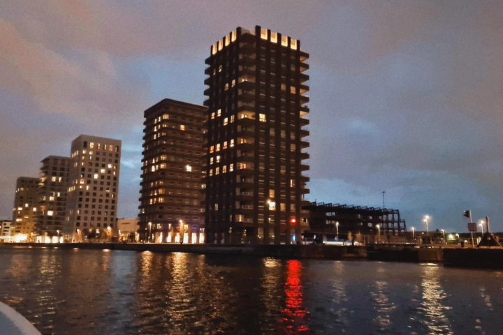 a large body of water with a city in the background