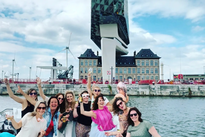 a group of people standing next to a body of water