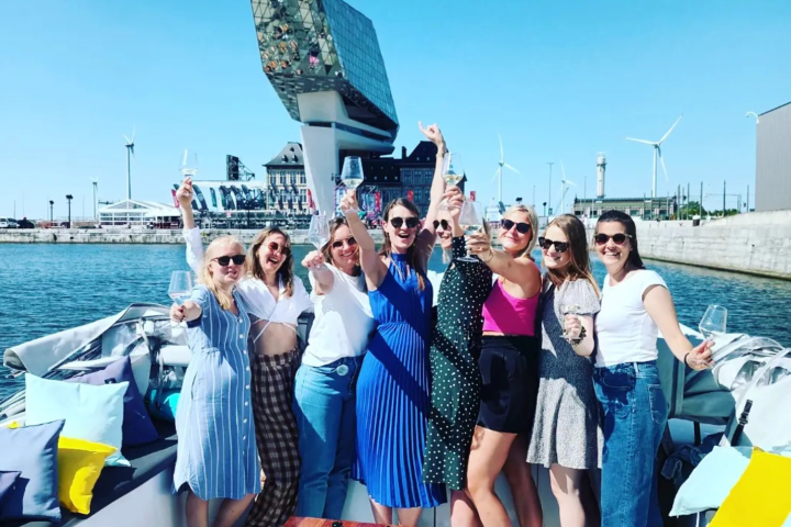 a group of people standing next to a body of water
