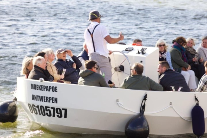 a group of people on a boat in the water