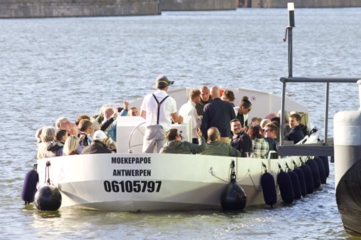 a group of people in a boat on a body of water