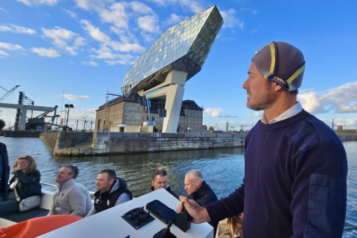 a group of people standing in front of a body of water