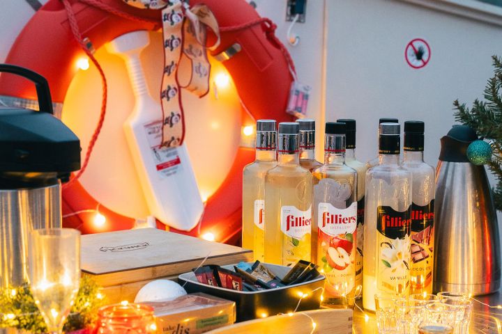 Outdoor bar setup with bottles, glasses, and a life preserver with lights.