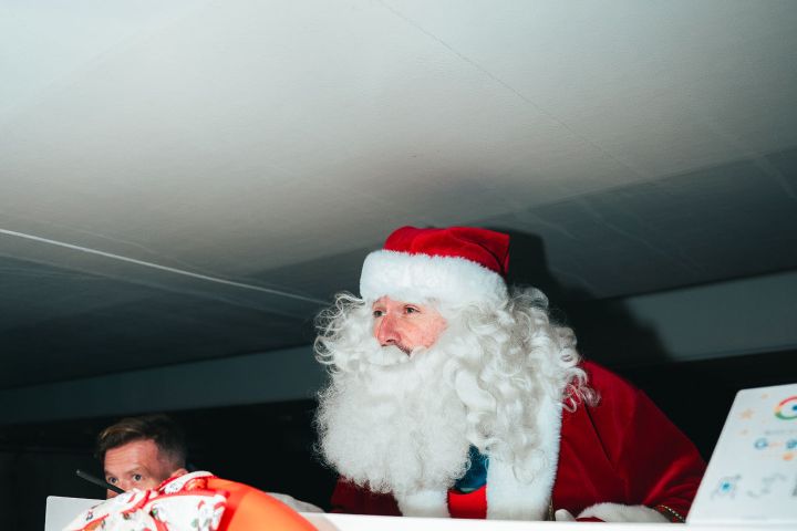 Santa Claus with a life preserver and no smoking sign on a white surface.
